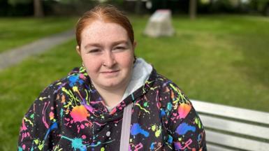 Leah sitting on a park bench 