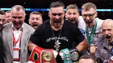 Oleksandr Usyk celebrates beating Daniel Dubois with his support team