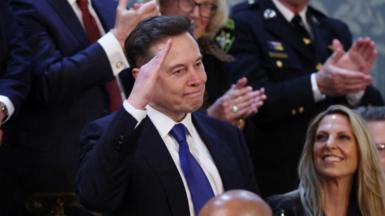 Elon Musk gives a salute during an address to Congress by US President Donald Trump