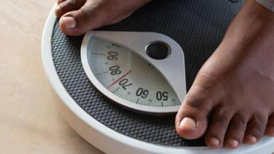 Person on weighing scales