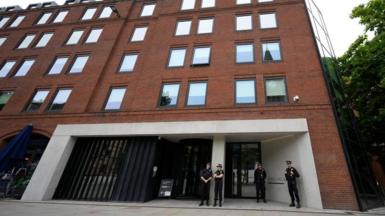 Police officers outside No 10 North, located in Heron House, central Manchester.