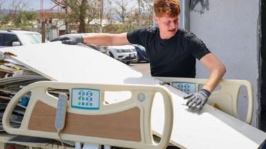 Man putting debris on hospital bed