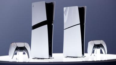 PlayStation 5 consoles next to controllers. They are white with black decals, set against a white background.