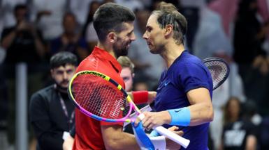 Novak Djokovic embraces Rafael Nadal at the net