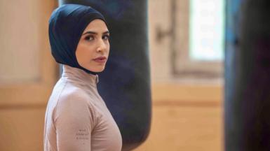 Zeina Nassar - wearing a hijab - looking at the camera during training