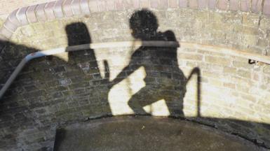 Shadow of a figure on a wall