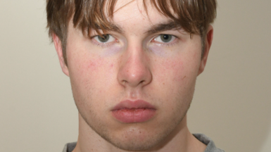 A mugshot of a young man staring at the camera.