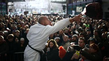 Workers sell off cuts of meat during the traditional Christmas Eve auction at Smithfield meat market in London, UK on 24 December 2025.