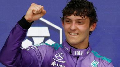 Kimi Antonelli clenches his fist in celebration on the podium after winning the Miami Grand Prix