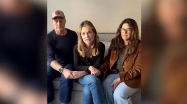 Savannah Guthrie, sitting in between two family members, addresses the camera in a video message