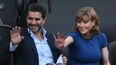Former Newcastle United shareholders Mehrdad Ghodoussi (L) and Amanda Staveley wave from the directors' box