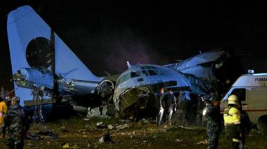 Members of the armed forces stand guard next to the wreckage of a military plane that crashed in el Alto, near La Paz on February 27, 2026