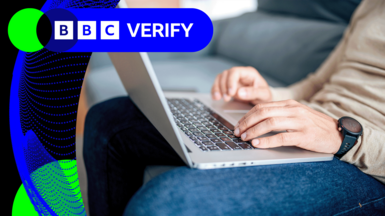 A stock image of a man typing at a laptop