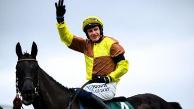 Paul Townend with his hand in the air while sat on the back of Galopin Des Champs