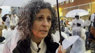 Israeli woman looking into the camera, with several more behind