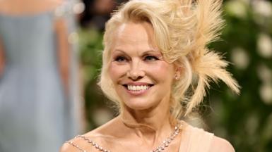 Pamela Anderson pictured in a beaded necklace at an event in 2024 in New York City