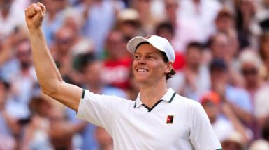 Jannik Sinner celebrates his victory over Novak Djokovic on Centre Court