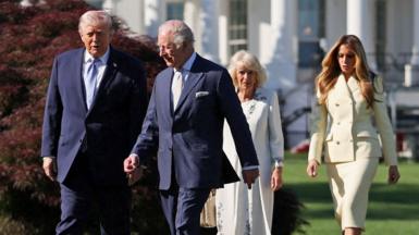 The Queen, King, Donald and Melania Trump converse as they walk outside the White House through the garden on Monday.