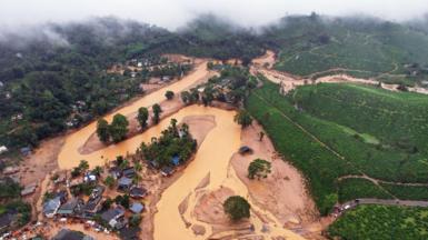 An overview of the disaster area shows mud flowing through the river