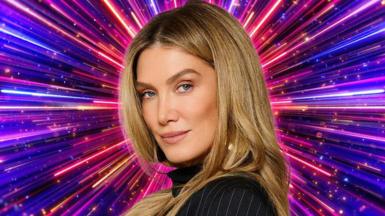 Delta Goodrem in front of a graphic showing numerous purple, pink and blue lines radiating from the centre, in a Strictly promotional photo