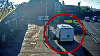 White van parked on petrol forecourt next to fuel pump 