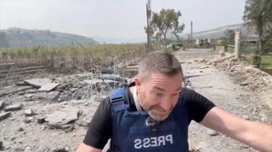 A still from a video of a British journalist ducking for cover from an Israeli strike in Lebanon.