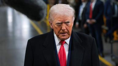 US President Donald Trump walks around a Ford factory