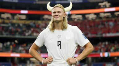 Erling Haaland wearing a plastic viking helmet after Norway beat Ivory Coast