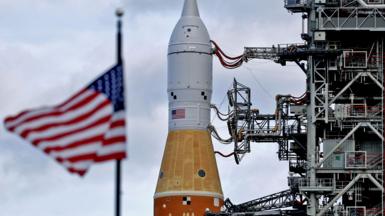 Artemis II and an American flag