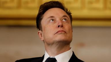 Elon Musk is pictured looking up