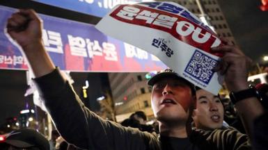 People call for the ousting of South Korean President Yoon Suk Yeoh in front of the National Assembly building in Yeouido, Seoul, South Korea, early on Wednesday 4 December 2024