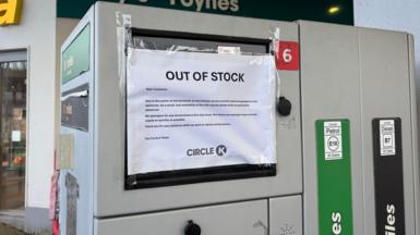 A petrol pump that has a page that says out of stock