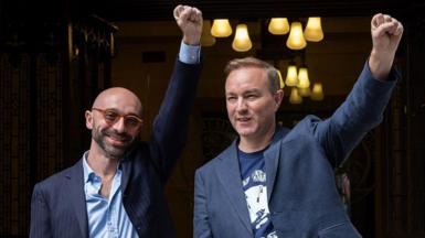 Carlo Palombo and Tom Hayes raise their fists in celebration outside the Supreme Court in London.
