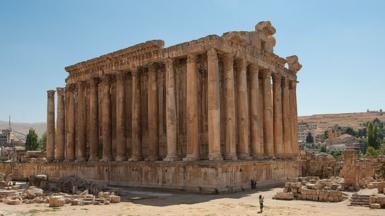 The ruins of a Roman temple, pictured from afar on a sunny day