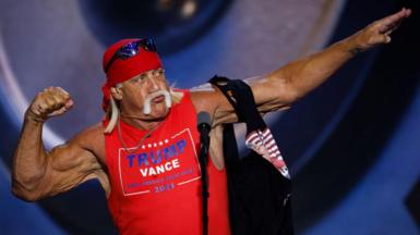 Hulk Hogan poses with an arm flexed after tearing off his T-shirt to reveal a bright red Trump-Vance tank top