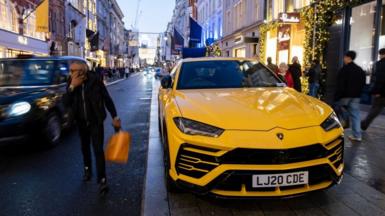 A yellow SUV on a street in London