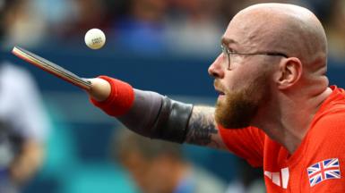 Martin Perry of Britain prepares to hit the ball, in a side view photo