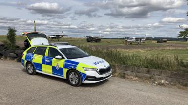 A police car parked near an airfield in Nottinghamshire