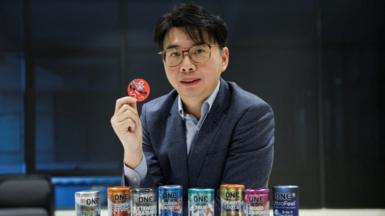 CEO of condom manufacturer Karex, Goh Miah Kiat, poses with condoms manufactured by the company in Malaysia