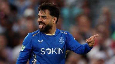 Rashid Khan of MI London celebrates a wicket, pointing and sticking his tongue out