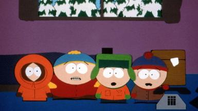 A still from South Park. Four cartoon characters dressed in winter clothing stand inside a building, looking shocked, with a window showing snowy trees in the background
