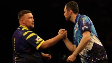 Luke Littler shakes hands with Luke Humphries at the Premier League Darts finals