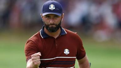 Golfer Jon Rahm clenching his fist at the Ryder Cup in 2025