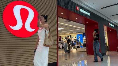 A woman in a white dress walks past a Lululemon store with its signature red logo displayed prominently on the wall, as shoppers browse inside the store, on 4 June, 2025 in Chongqing, China.