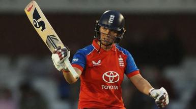 Alice Capsey raises her bat for fifty v New Zealand