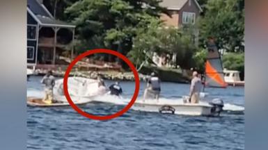 Red circle around teenager jumping on a boat