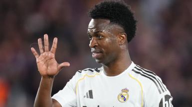 Vinicius Jr holds up his hand during a Champions League match for Real Madrid