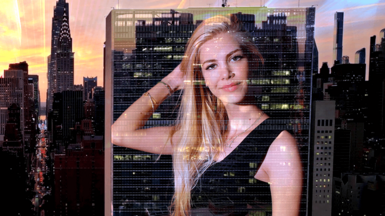 Kat Torres' picture projected onto a stylised backdrop of the New York skyline