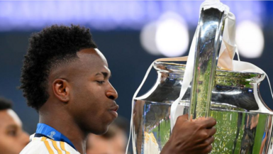 Vinicius Jr kisses the Champions League trophy