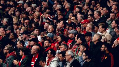 Manchester United fans applaud before kick off of a Premier League fixture against Liverpool